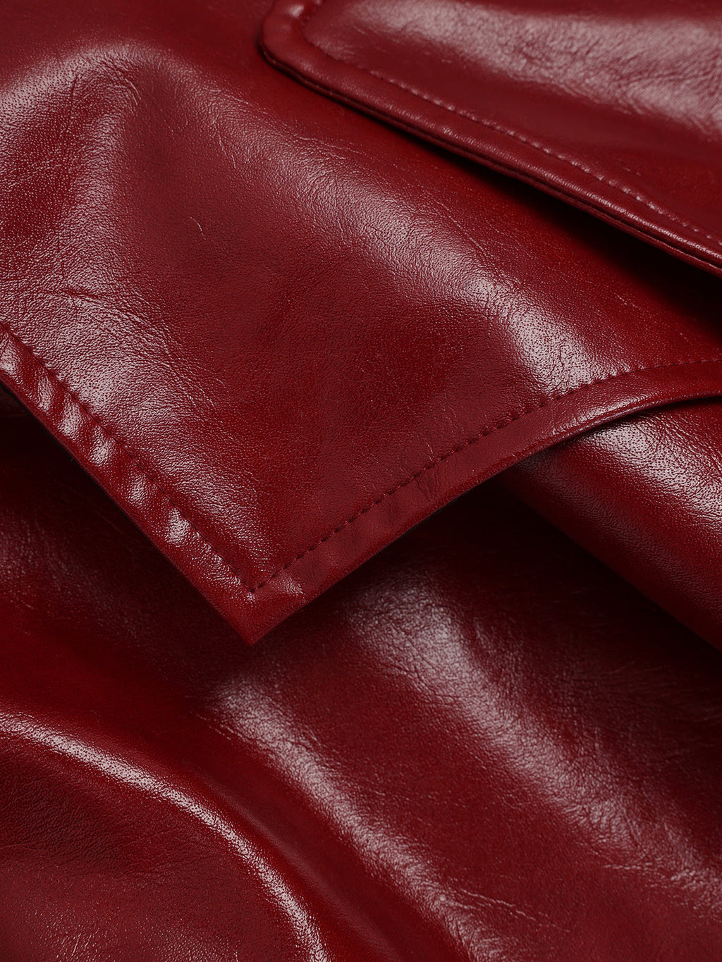 Smooth, glossy dark red faux leather trench coat with rich texture and defined seams.