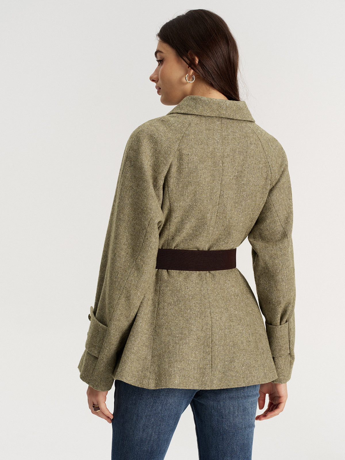 An olive green LA FINE FLEUR shawl collar wool-blend belted blazer with denim jeans.