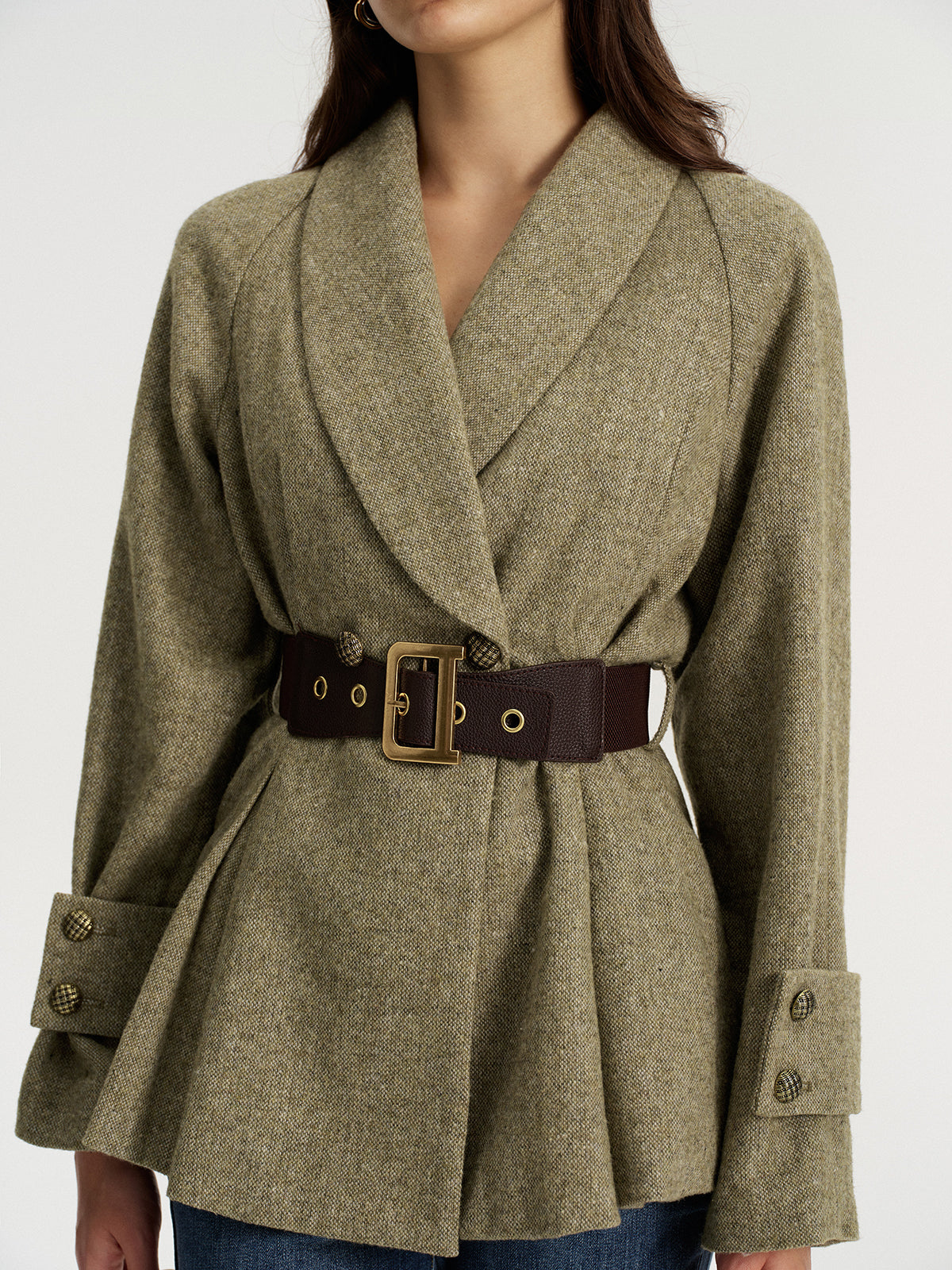 Olive green wool-blend blazer with a shawl collar and wide brown belt, paired with blue jeans.