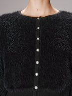 Textured black knit faux mink cardigan with shiny round buttons and cropped silhouette.