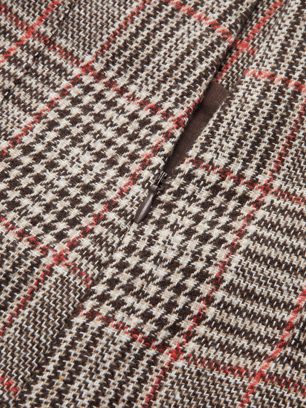 Brown, beige, and red checkered tweed shorts with belt loops and a zippered pocket.