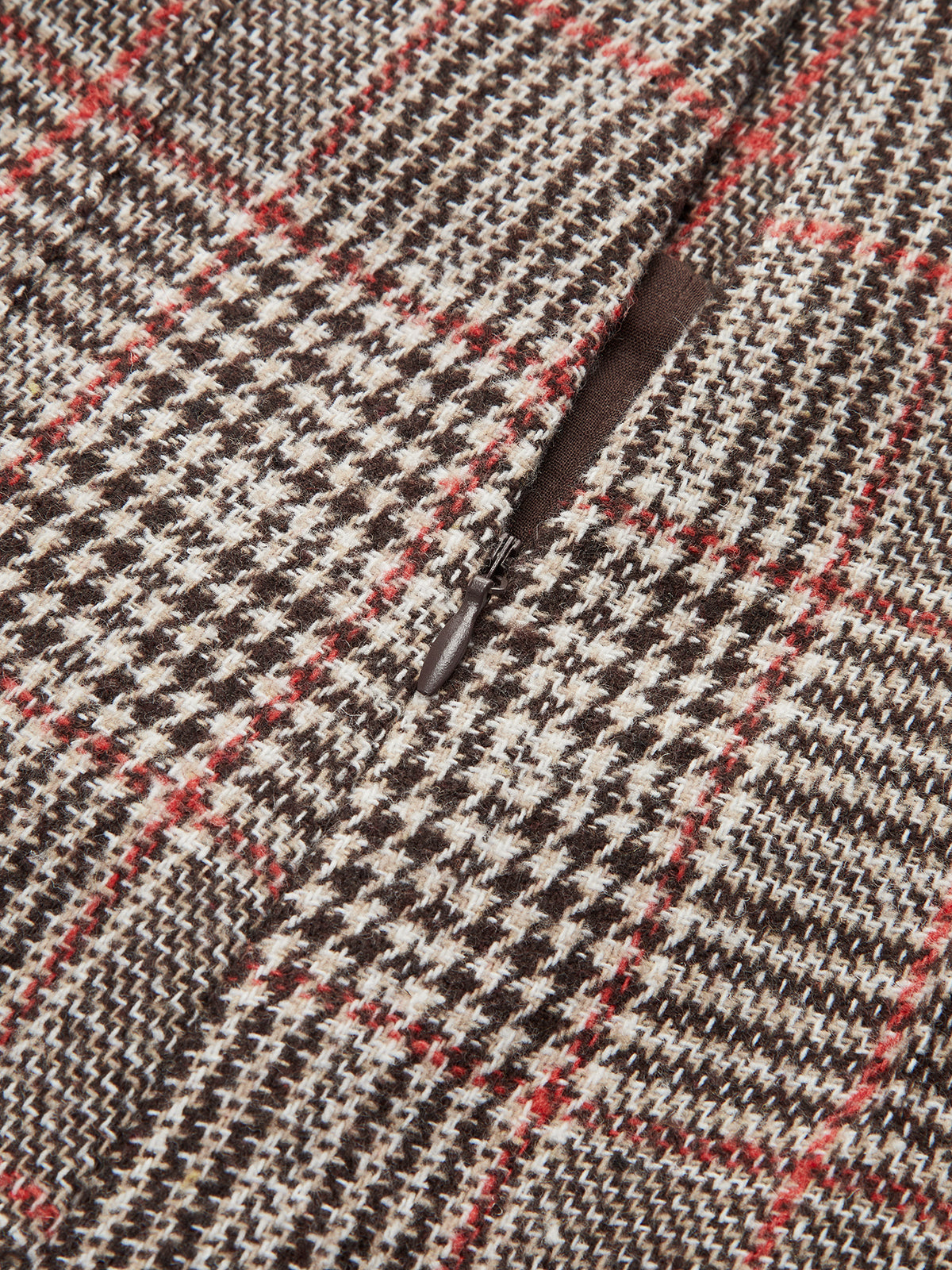 Brown, beige, and red checkered tweed shorts with belt loops and a zippered pocket.