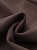 A close-up of the soft, dark brown LA FINE FLEUR pullover sweatshirt fabric and folds.