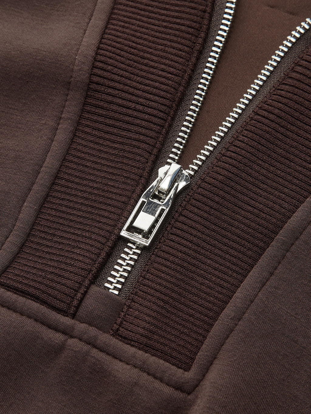 V-neck half-zip pullover with metallic zipper, ribbed fabric, and detailed visible stitching.