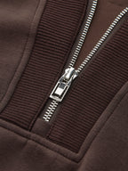 V-neck half-zip pullover with metallic zipper, ribbed fabric, and detailed visible stitching.