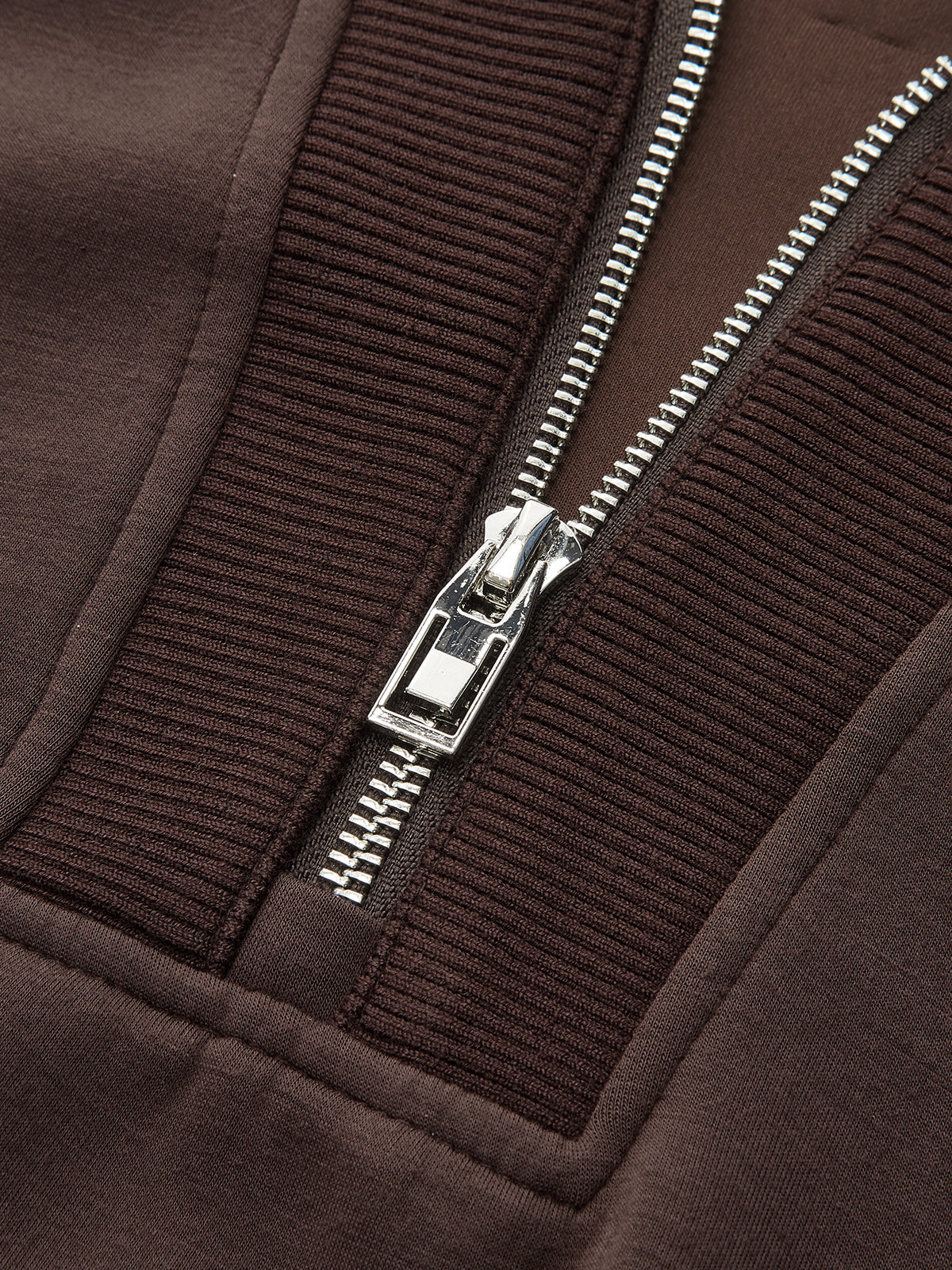V-neck half-zip pullover with metallic zipper, ribbed fabric, and detailed visible stitching.
