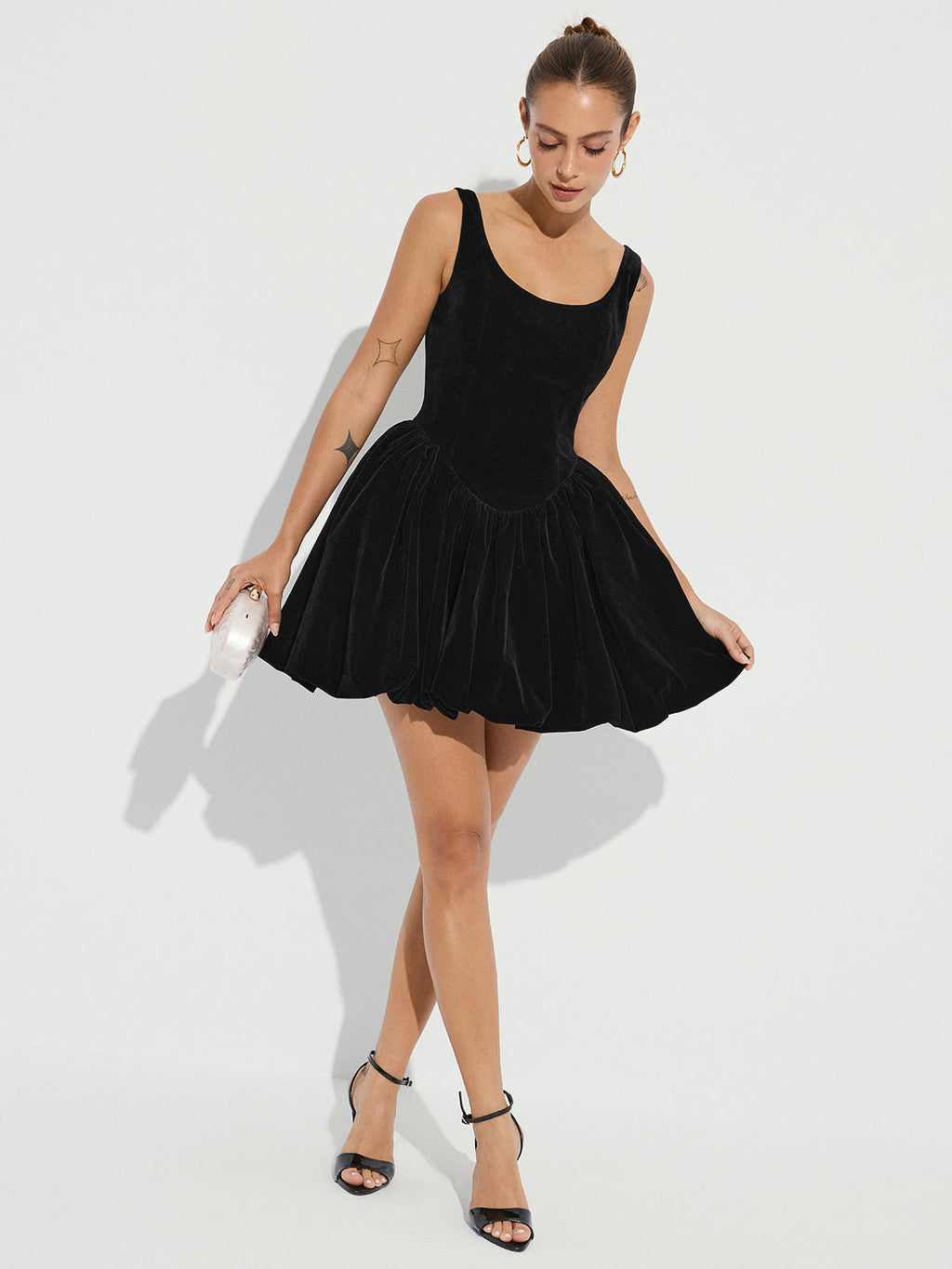 Black velvet mini dress with bubble hem and straps, an elegant choice for evening parties.