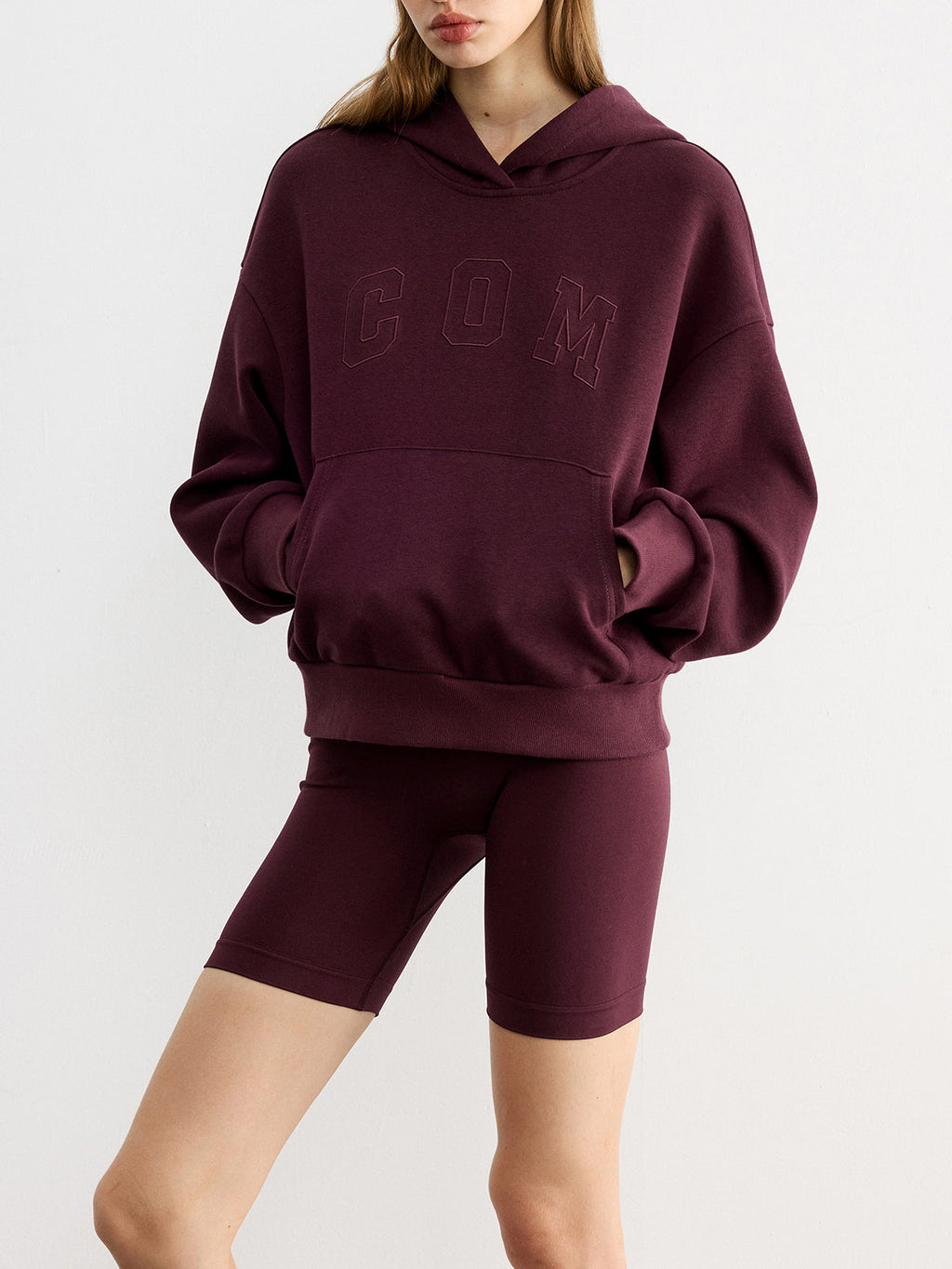 A burgundy LA FINE FLEUR Embroidered Letter Design Casual Hoodie with a front pocket.