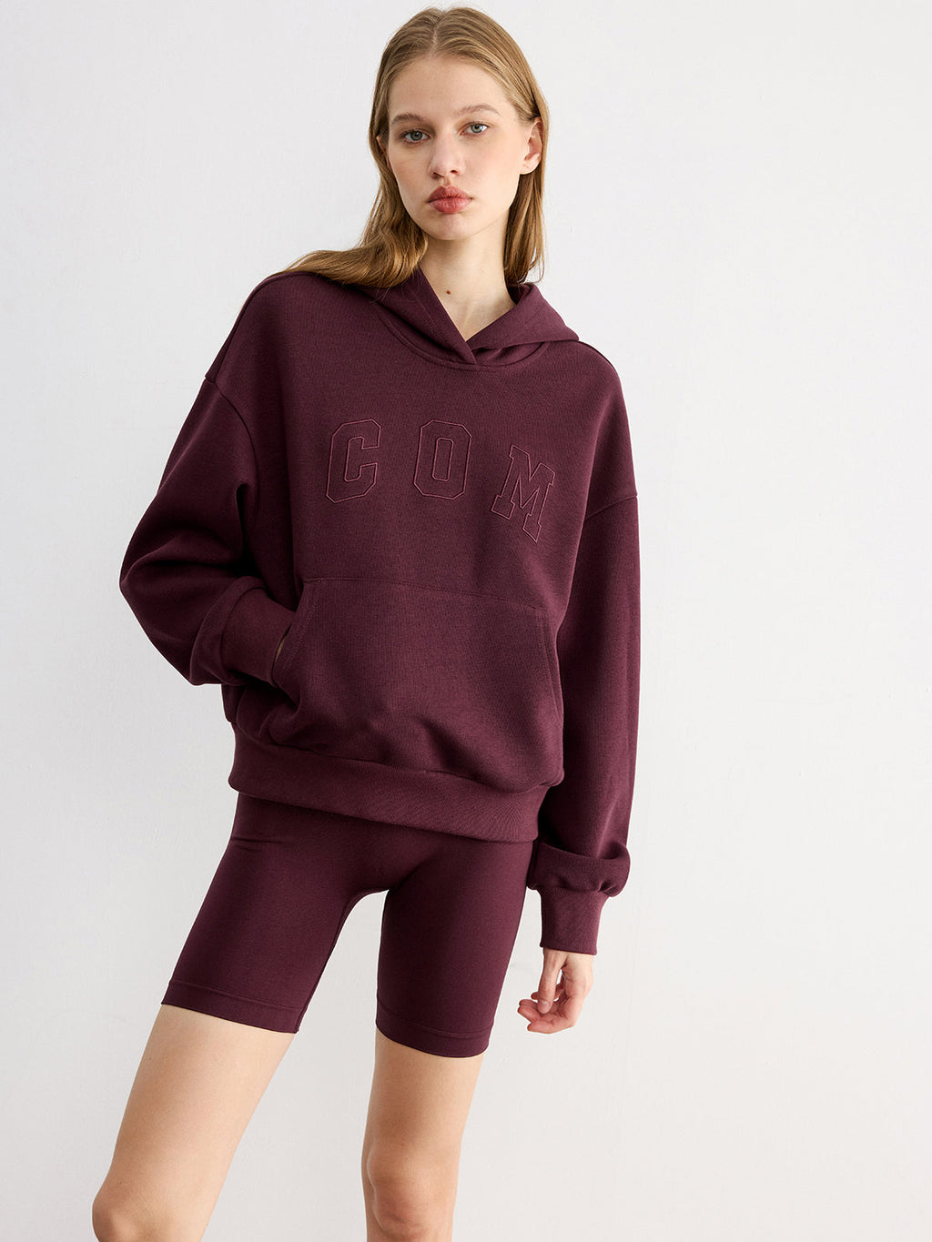 Maroon LA FINE FLEUR Embroidered Letter Design Casual Hoodie paired with matching bike shorts.