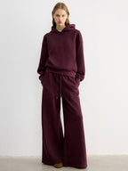 LA FINE FLEUR embroidered letter casual hoodie and matching wide-leg pants in coordinated style.