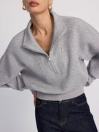 LA FINE FLEUR Half-Zip Cropped Sweatshirt in Oversized Fit paired with dark blue jeans.