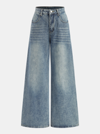 High-waist denim pants with wide legs, subtle fading, front closure, and two pockets.