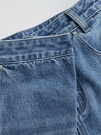 Mid-waist wide-leg jeans with asymmetric cut, defined waistband, front pocket, belt loop, and seams.