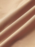 Light beige, fine ribbed Deep V-Neck Bodysuit with Buckle and long sleeves, softly folded.