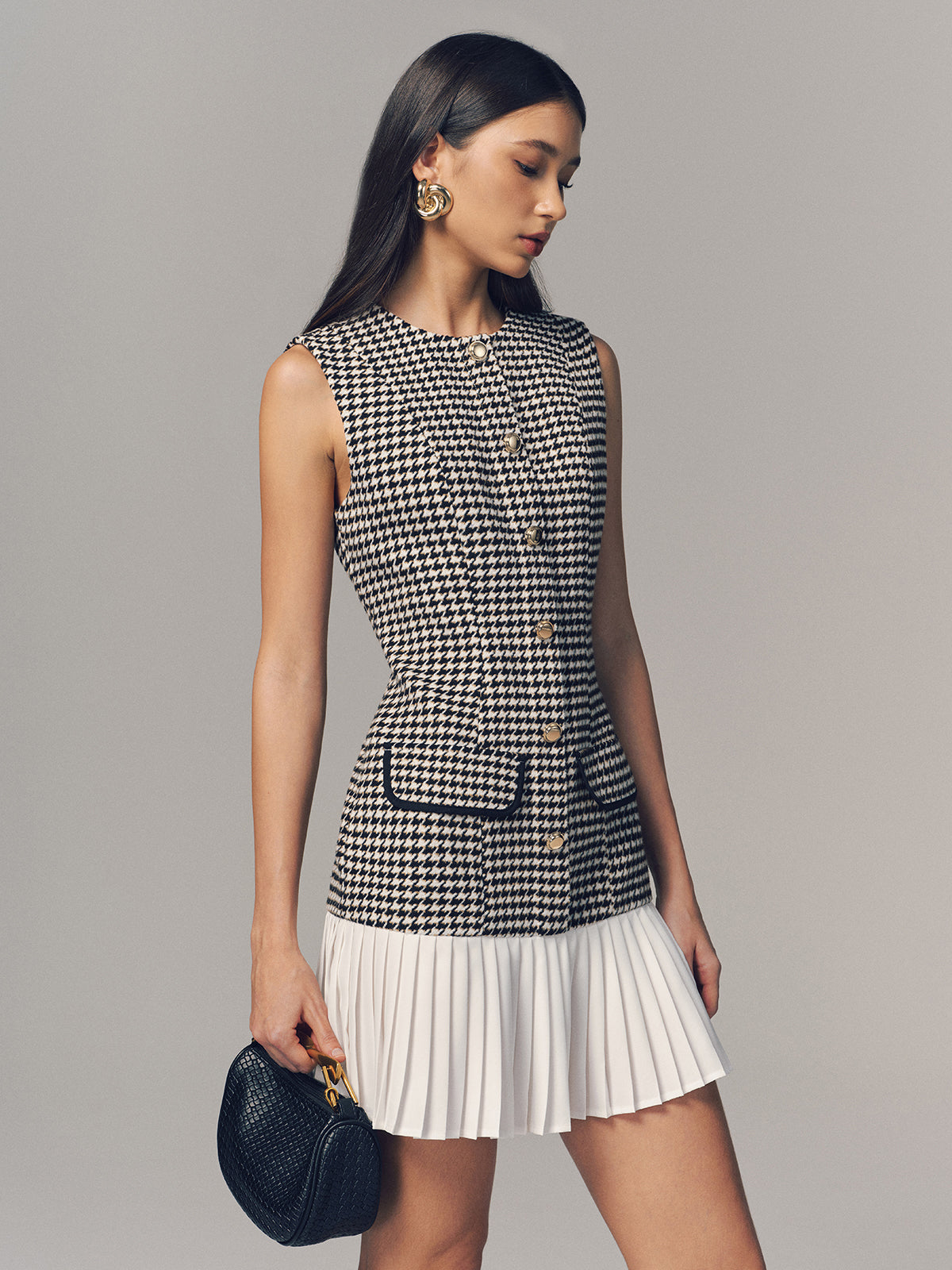 LA FINE FLEUR houndstooth sleeveless mini dress with pleated hem detail.