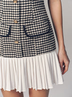 The LA FINE FLEUR houndstooth sleeveless mini dress with gold buttons and pleated hem.