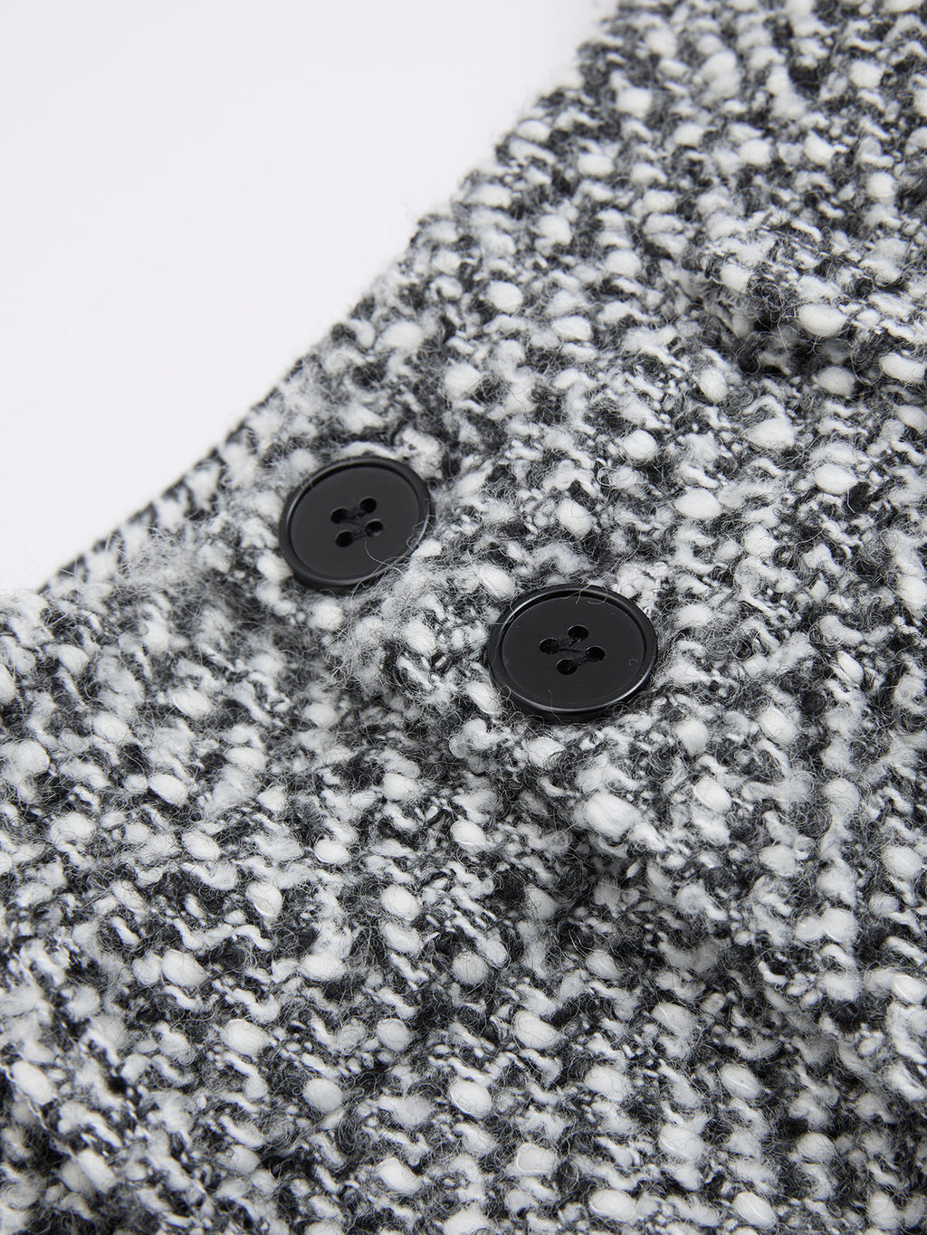 Double waistband wool blend tweed trousers with textured black-and-white knit and speckled pattern.