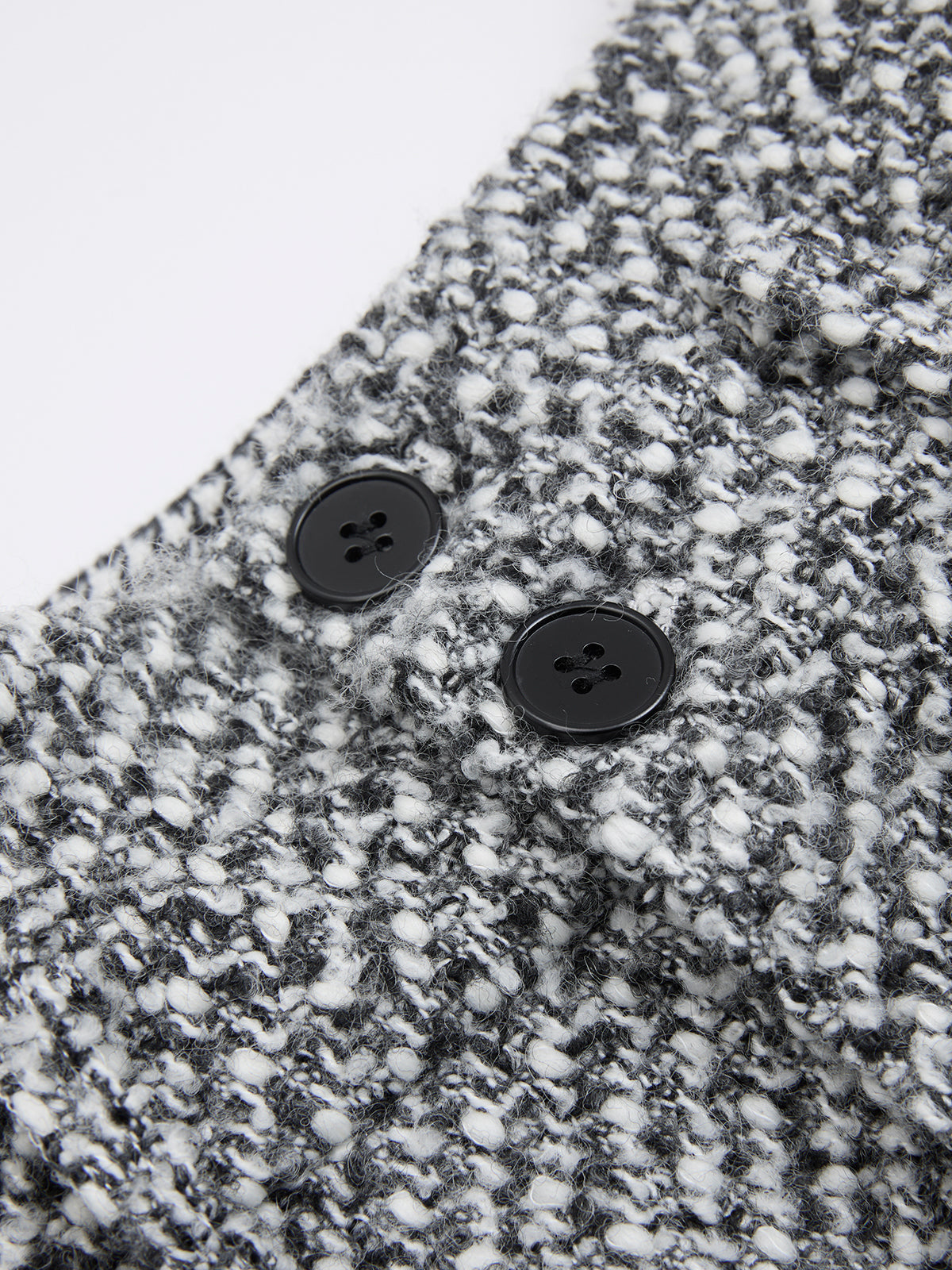 Double waistband wool blend tweed trousers with textured black-and-white knit and speckled pattern.