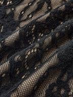 Elegant backless cami bodysuit with black floral lace over beige and delicate embroidered details.