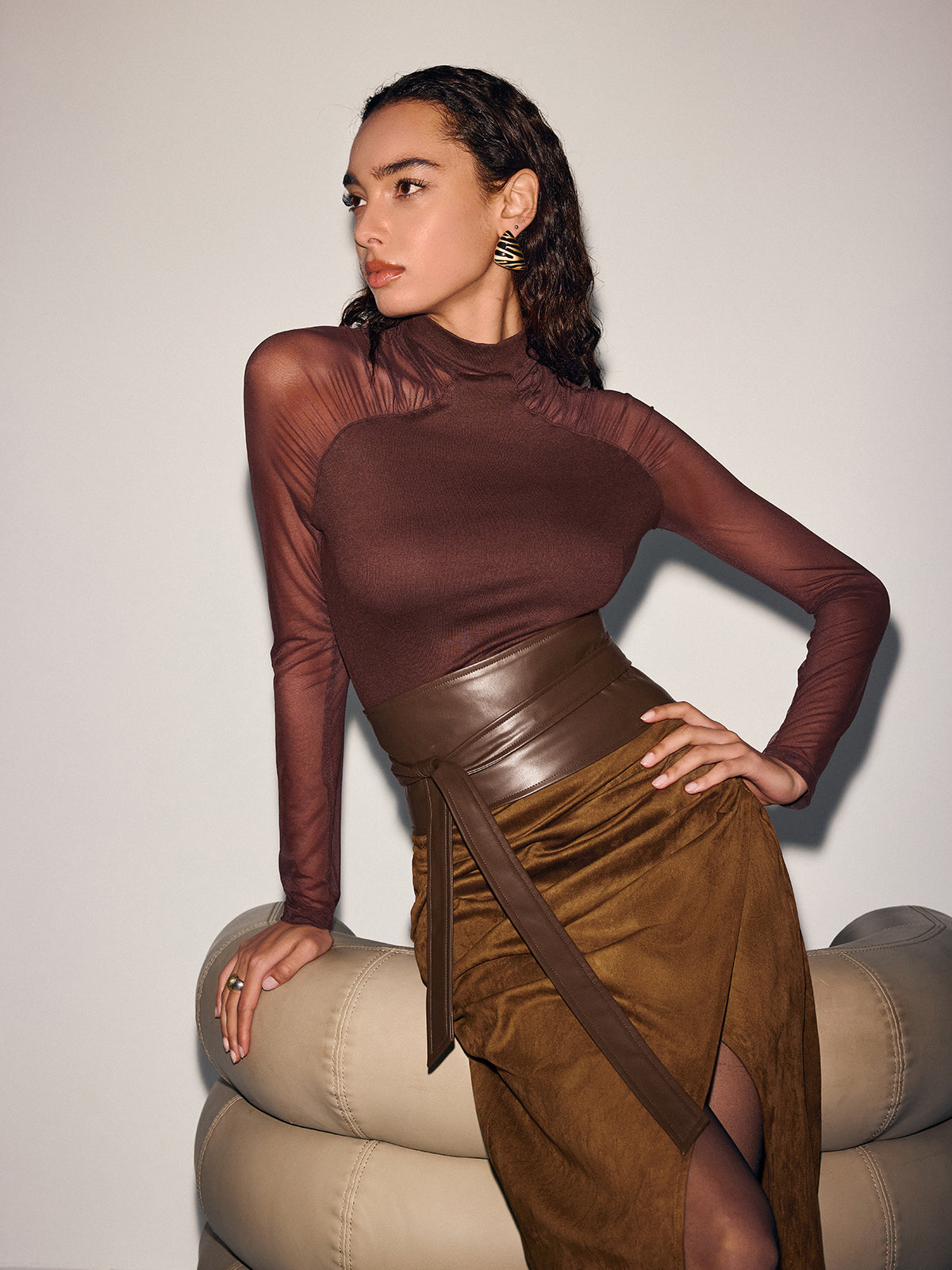 Brown mesh top, wide leather belt, and suede midi skirt with leather trim and waist tie.