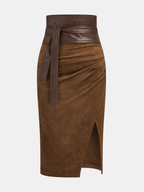 A suede midi skirt with leather trim, waist tie, high waist, and dramatic thigh-high slit.