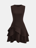 Sleeveless mini dress with fitted bodice, crew neck, asymmetric ruffle hem in dark brown.