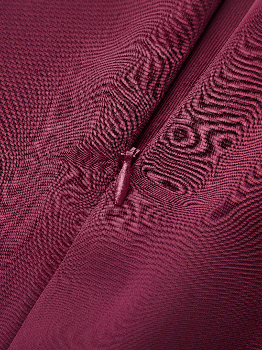 Maroon satin mock neck blouse with elegant neck tie, showcasing textured fabric and intricate weave.