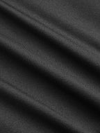 Close-up of black V-neck bodysuit with lace accents, ruching, and soft diagonal folds.