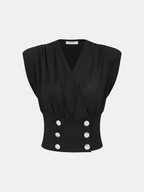 Black slim-fit sleeveless blouse with gathered shoulders, wrap front, fitted waist, metallic buttons.