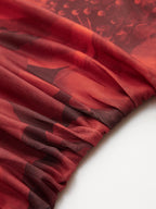 Ruched red and black mesh mini dress with printed pattern and gathered elastic seam.