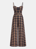 Brown and black plaid wide-leg jumpsuit with belted waist, thin straps, fitted bodice.