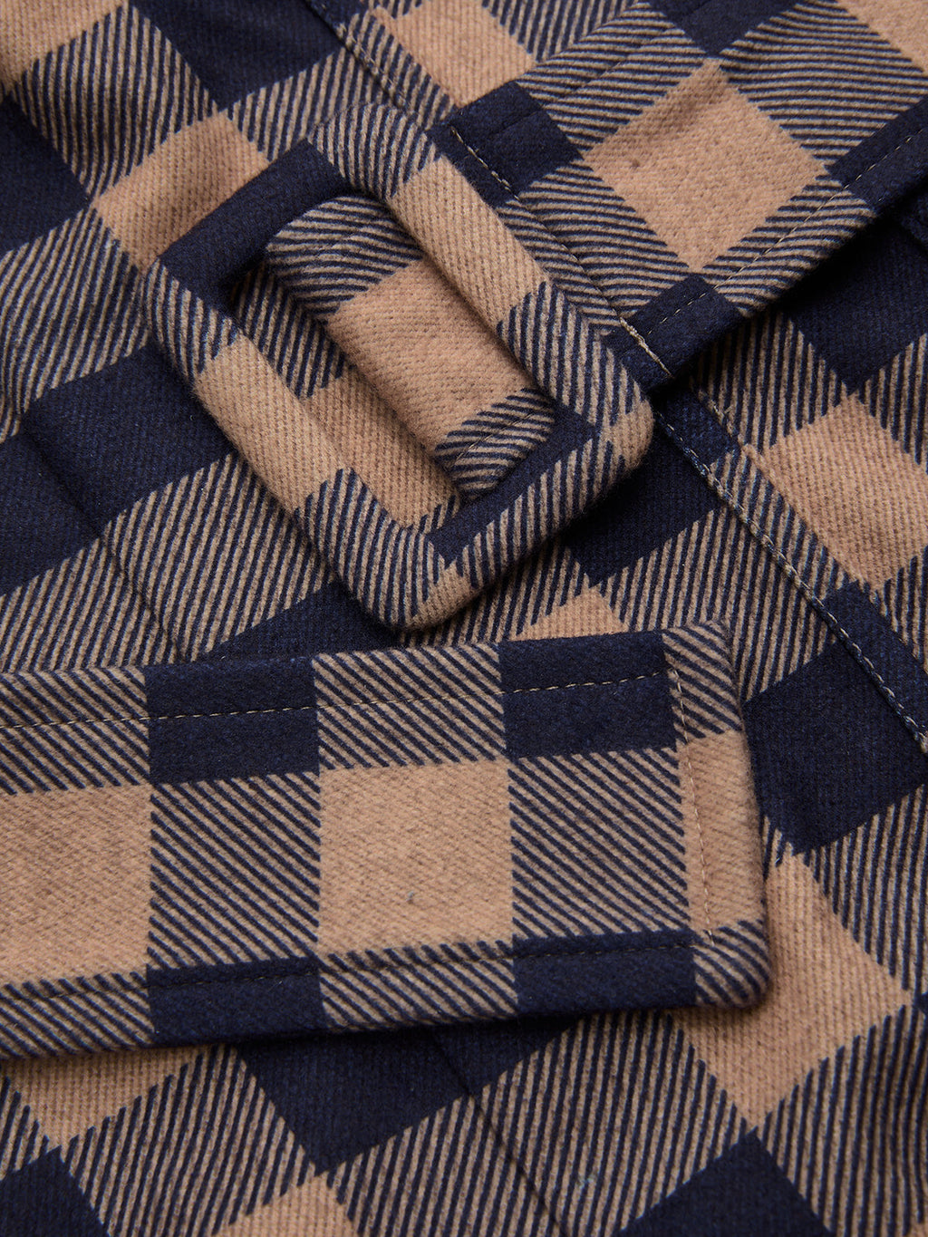 Plaid wide-leg jumpsuit with brown and navy checks, belted cami top, matching buckle.
