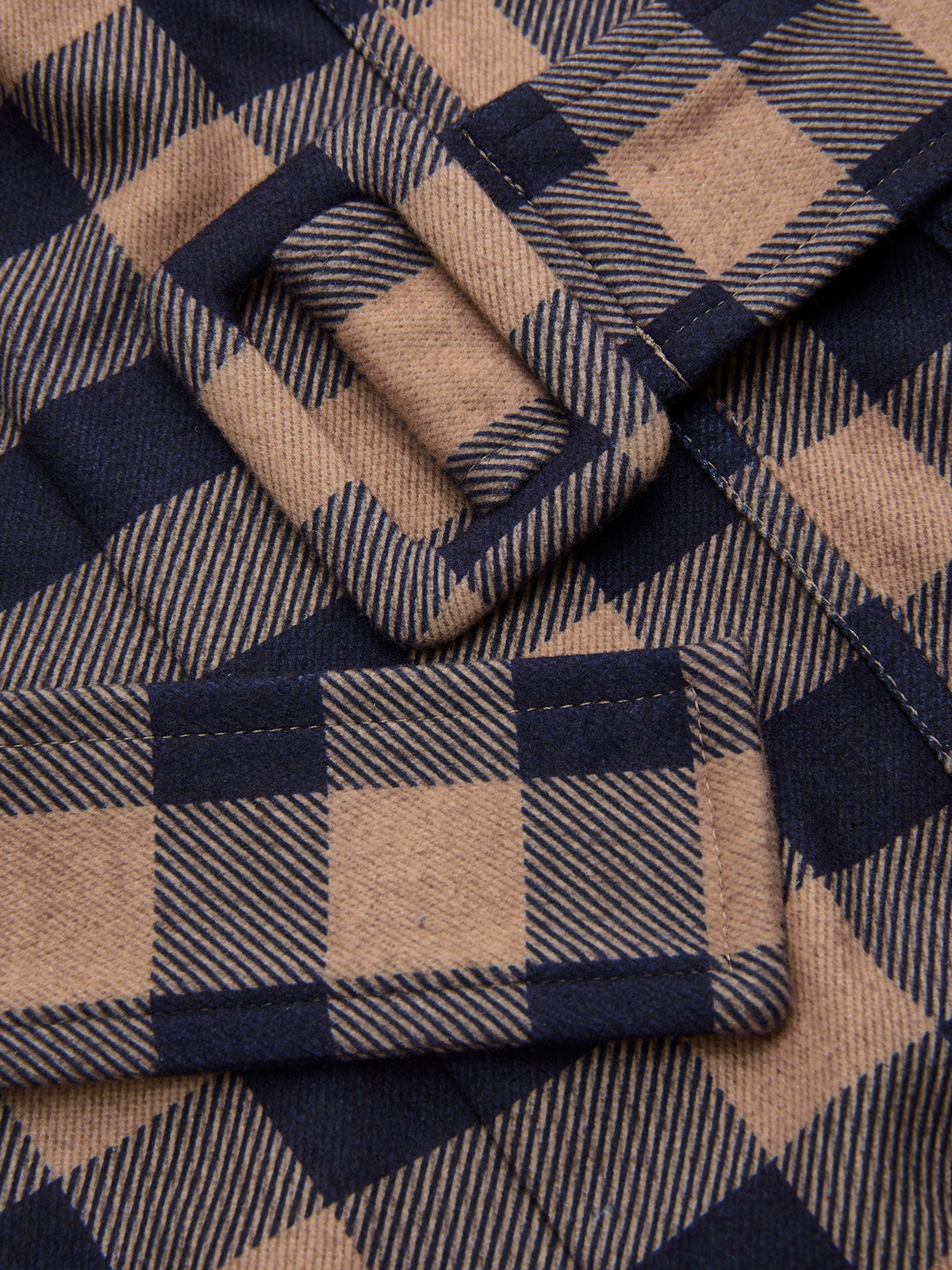 Plaid wide-leg jumpsuit with brown and navy checks, belted cami top, matching buckle.