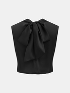 Sleeveless satin cowl-neck blouse with a large, elegant bow at the back neckline.