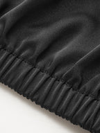 Black, shiny ruched satin blouse with cowl neck and elastic waistband detailing.
