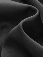 A sleek black satin sleeveless cowl-neck blouse with a subtle sheen and silky texture.