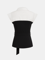Sleeveless color block blouse with collared neckline, white cap sleeves, and fabric-tied belted waist.
