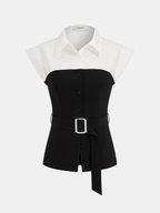 Sleeveless color block blouse with white collar, black button-down bodice, silver-buckled belt.