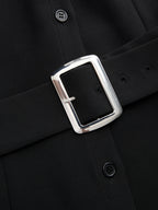 Sleeveless color block blouse with collar and black belt, silver rectangular buckle detail.