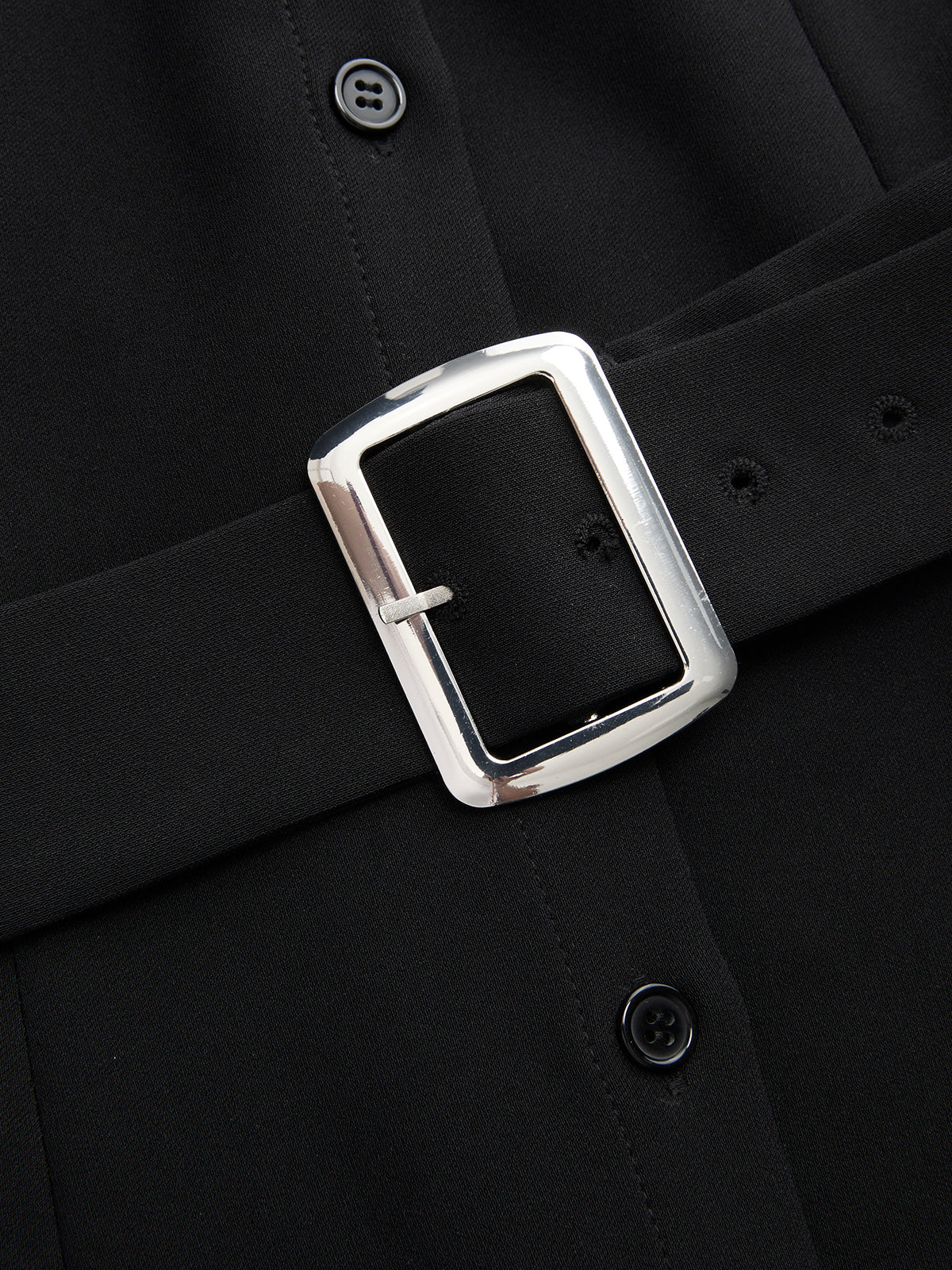 Sleeveless color block blouse with collar and black belt, silver rectangular buckle detail.
