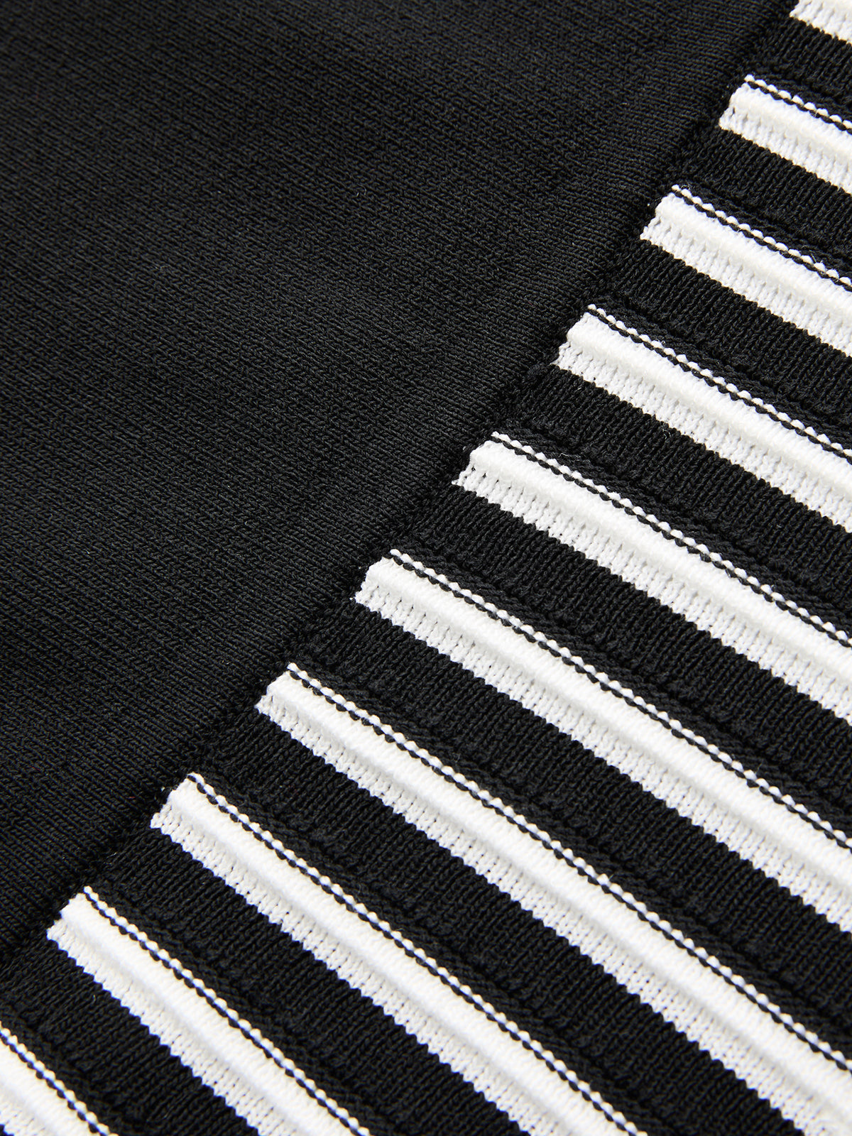 Sleeveless mock neck midi dress with split black and striped panels, stretch-knit texture.