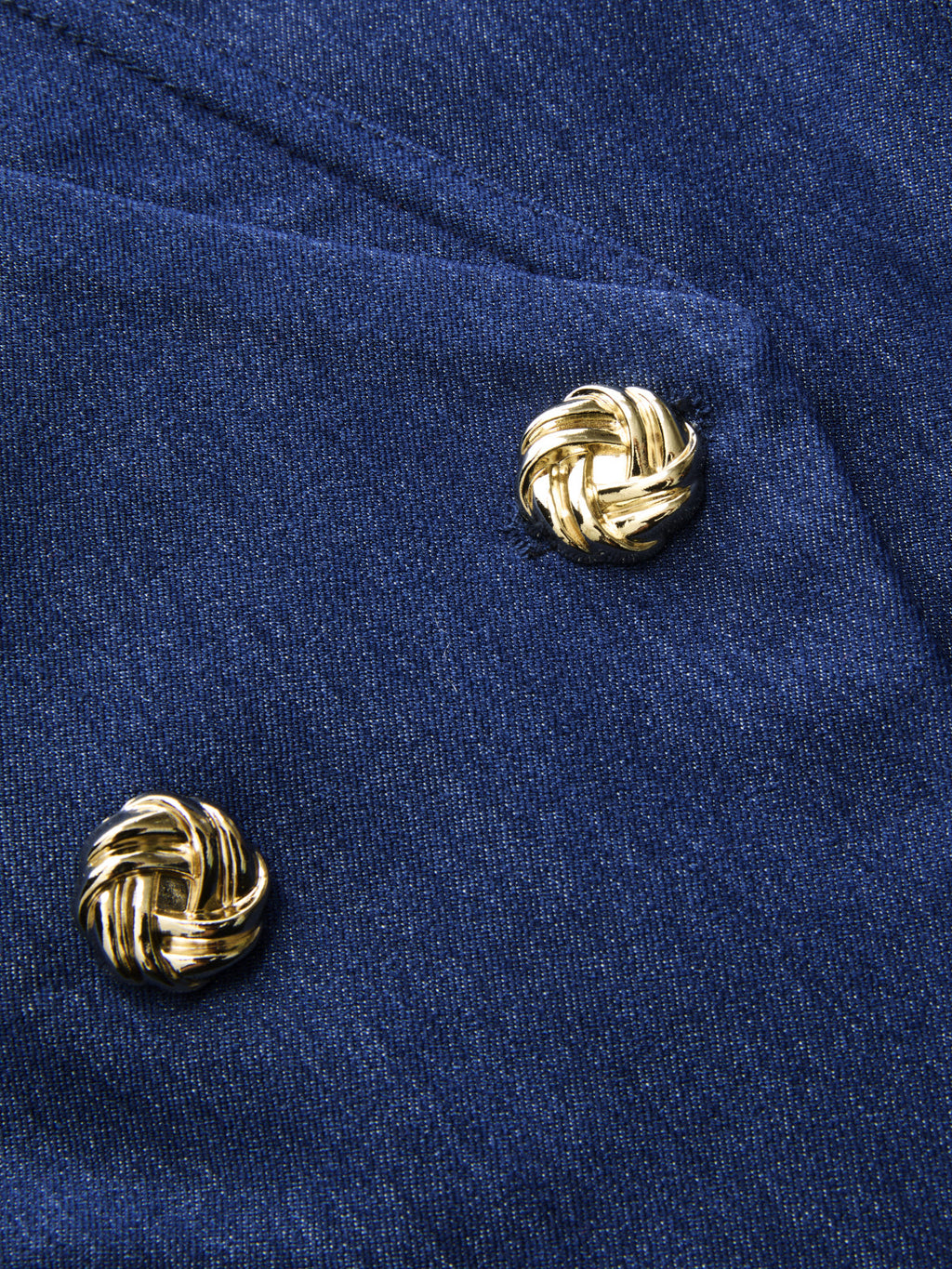 Dark blue double-breasted blazer vest with gold knot-shaped buttons for an elegant effect.