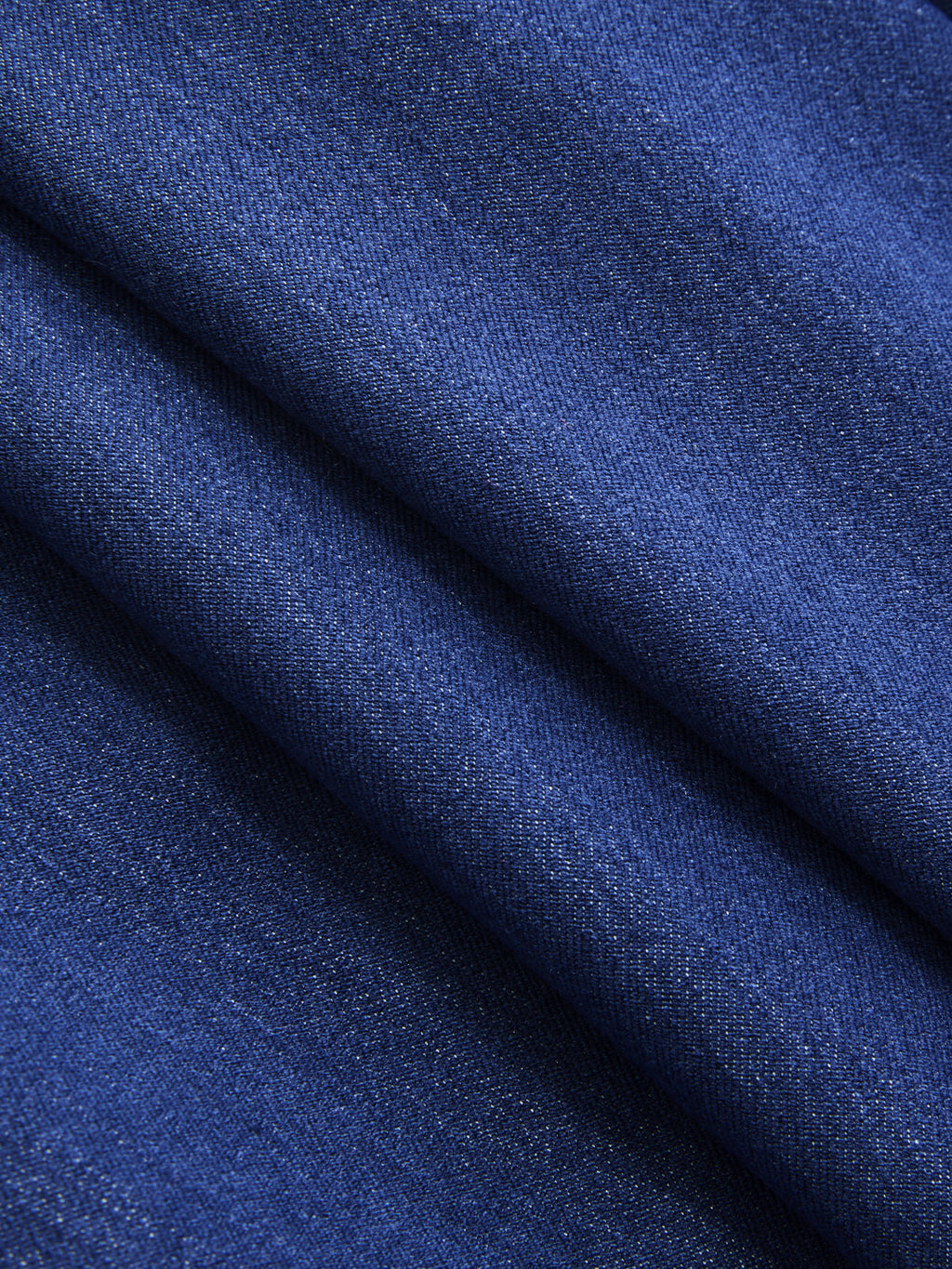 Sleeveless double-breasted blazer vest made of dark blue denim with fine woven texture.