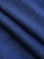 Sleeveless double-breasted blazer vest made of dark blue denim with fine woven texture.
