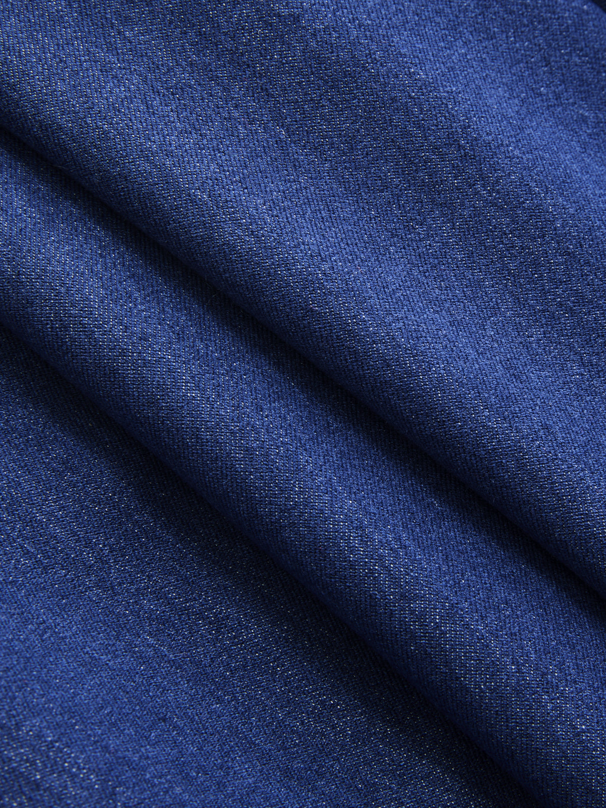Sleeveless double-breasted blazer vest made of dark blue denim with fine woven texture.