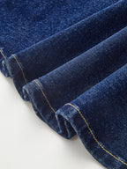 Dark blue denim mini dress with yellow stitching and dual buckle belt accents.