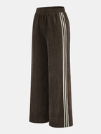 Wide-leg brown corduroy pants with elastic waistband and bold white stripes down sides.