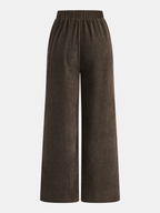 Brown wide-leg corduroy pants with striped side detail and elastic waistband, viewed from back.