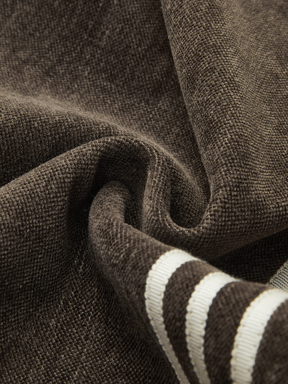 Wide-leg brown corduroy pants with two parallel white side stripes and gentle folds.