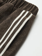 Wide-leg corduroy pants with an elastic waistband and two parallel white side stripes.